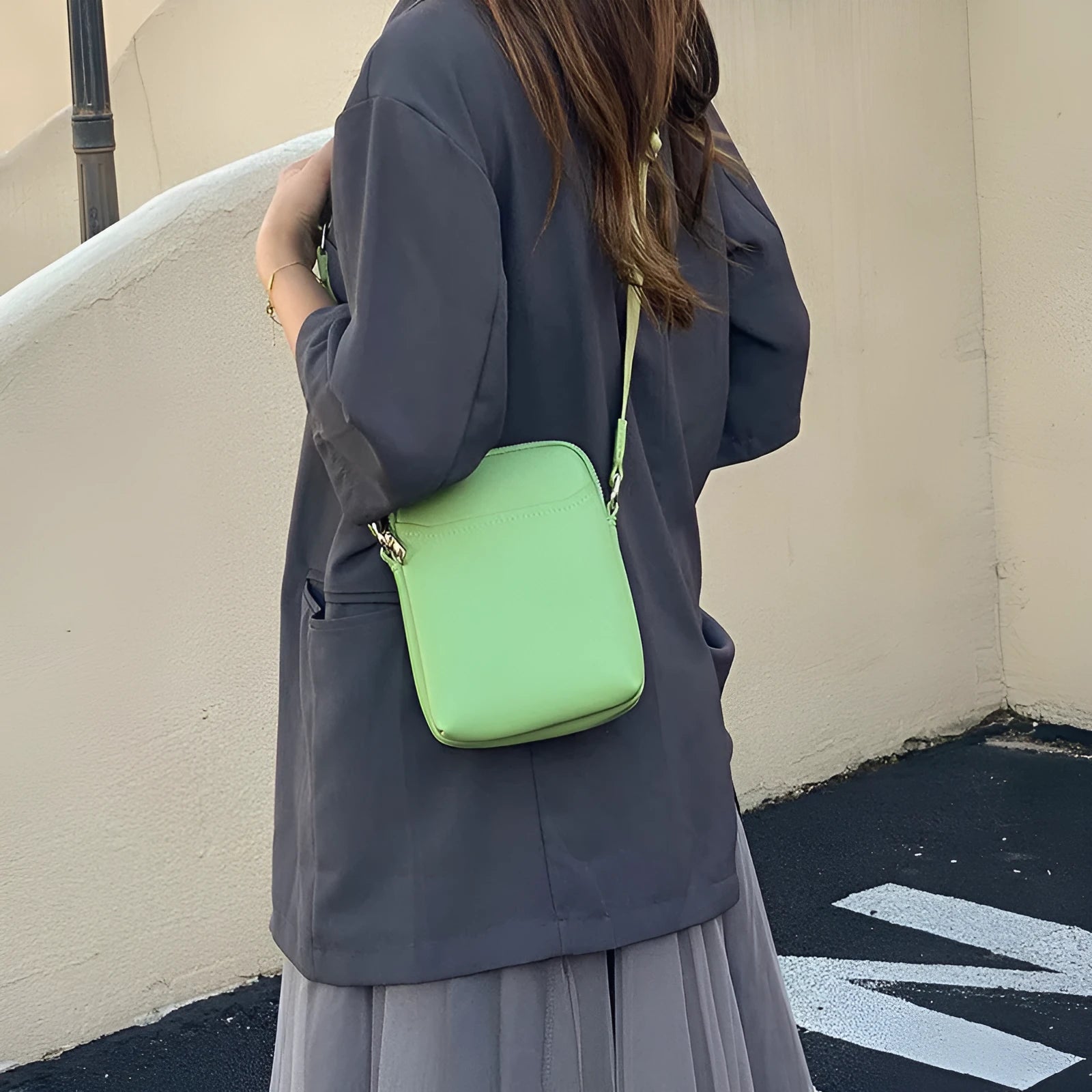 Solid colour crossbody phone bag for women in black, made from PU with an adjustable strap.