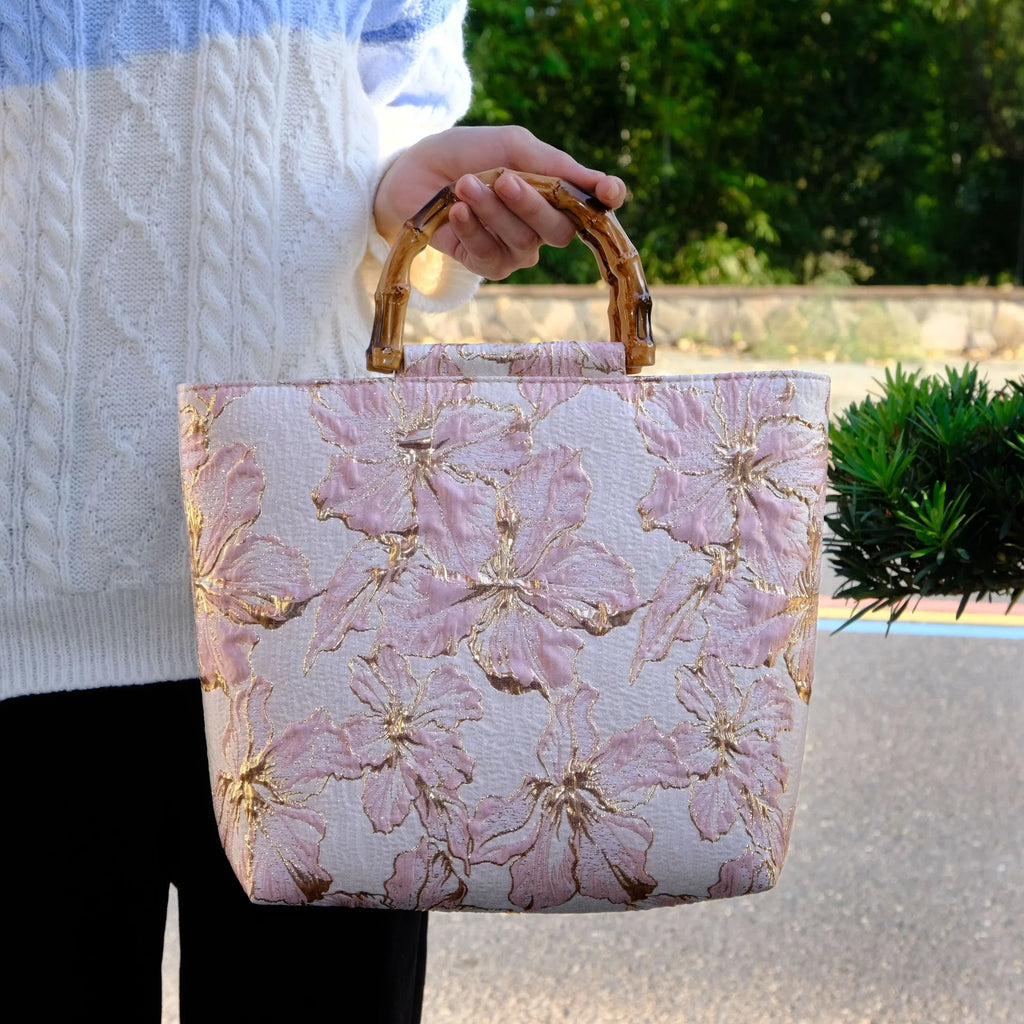 Light blue women's canvas bag with gold bronzing flower pattern showing double shoulder straps and square shape