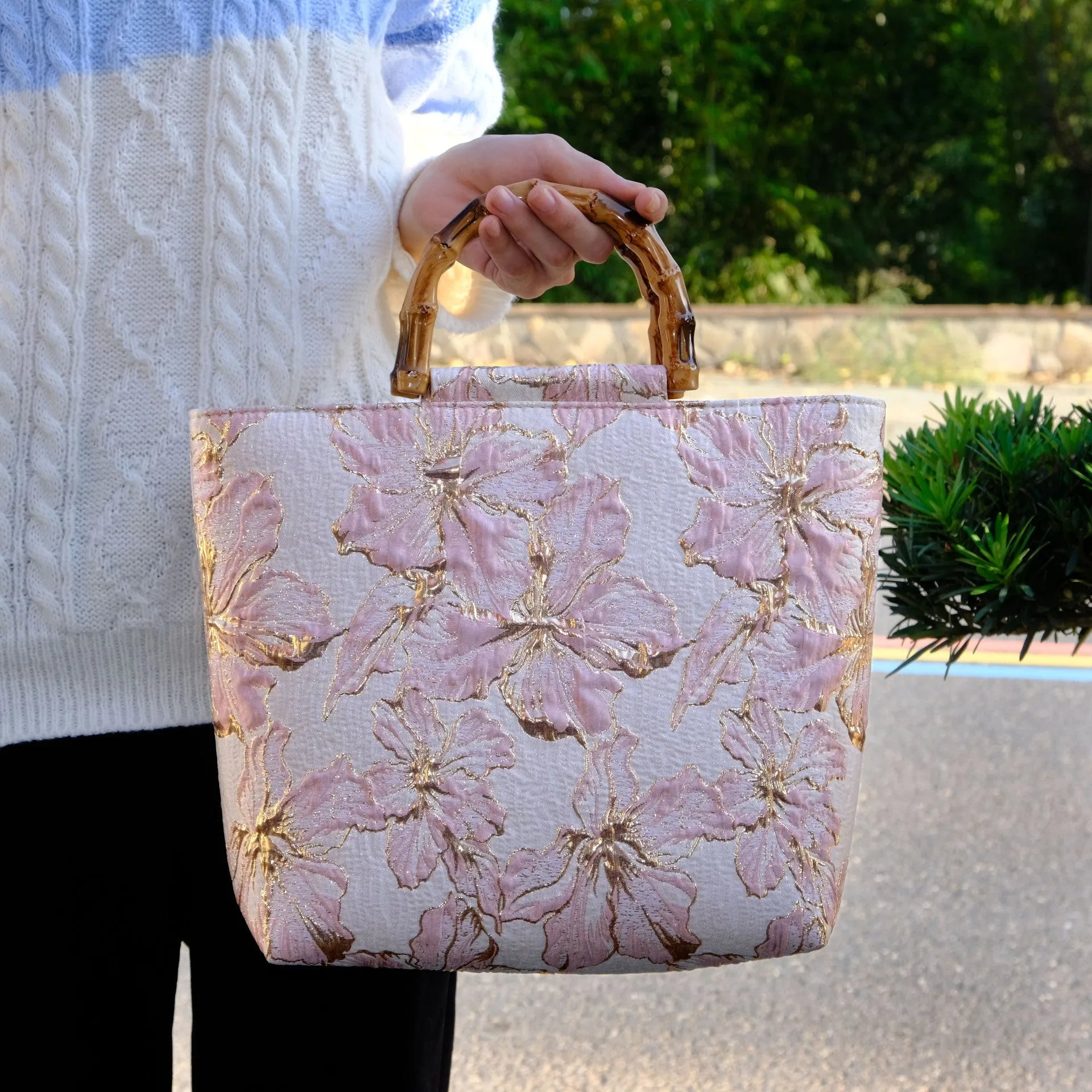 Light blue women's canvas bag with gold bronzing flower pattern showing double shoulder straps and square shape