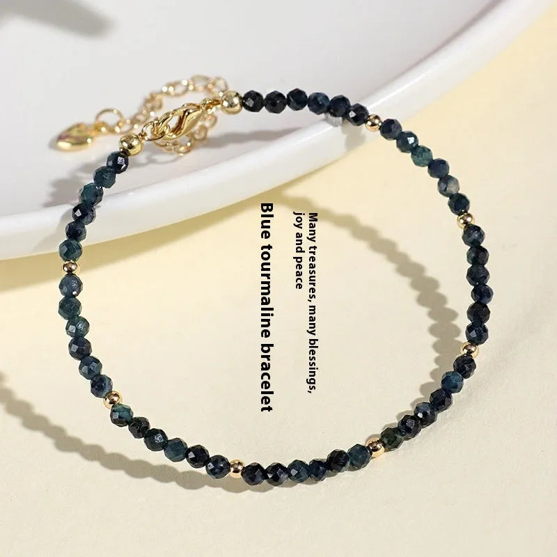 Women's blue tourmaline bracelet with 3mm beads and spacer bead design.