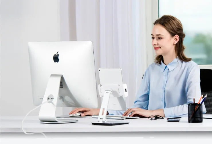 Foldable aluminium desktop stand holding a tablet at an angle.