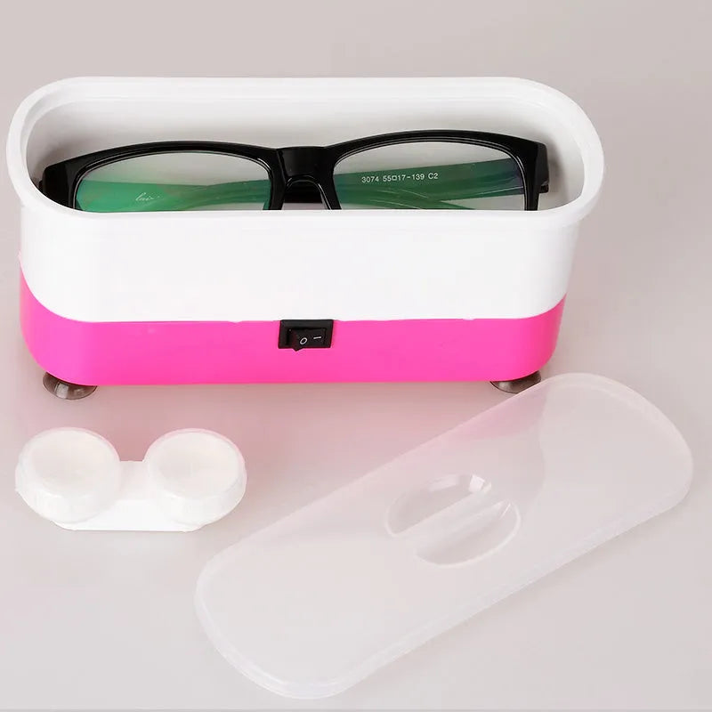 Blue plastic analog ultrasonic cleaner for glasses and contact lenses, 17x6x8 cm, with suction cups on a table