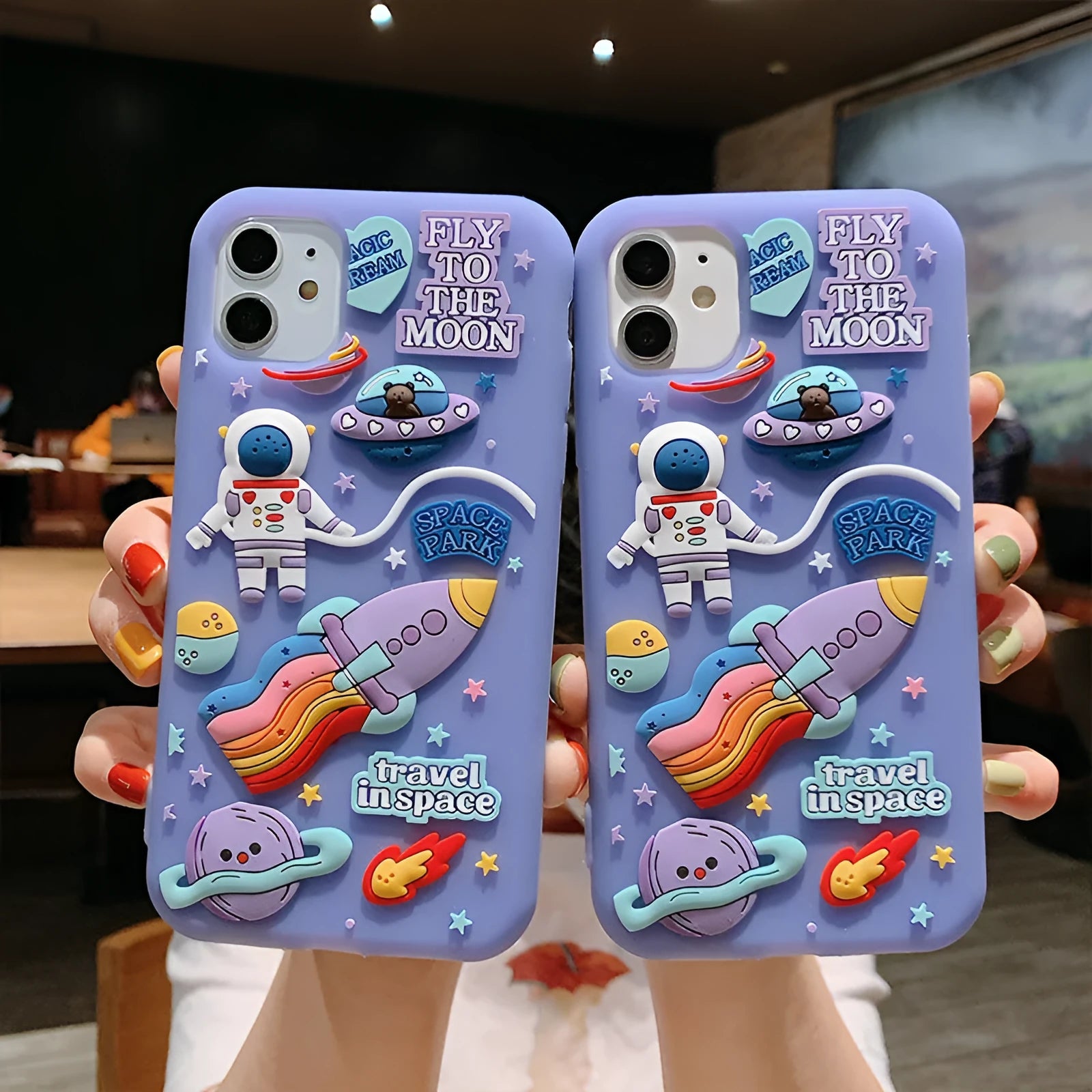 Purple silicone iPhone case with cartoon astronaut graphic for models 7, 8, X, and 11