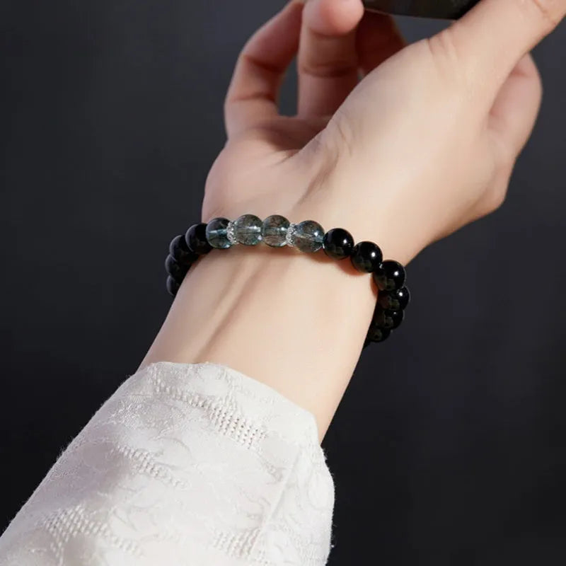 Chinese style black geometric bead bracelet with sterling silver components on wrist