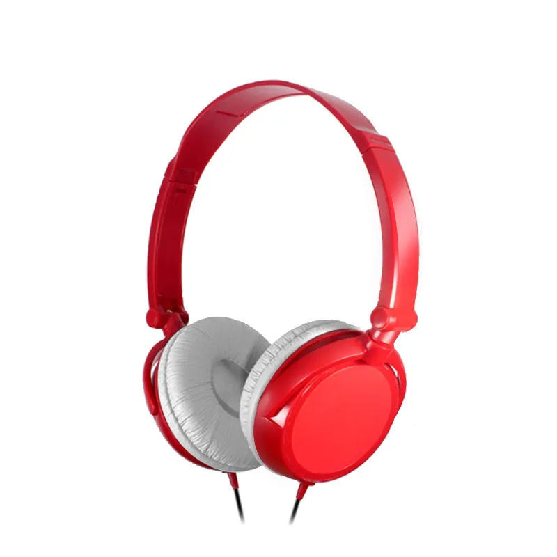 Red folding over-ear wired headphones with adjustable headband and 3.5mm plug on a table