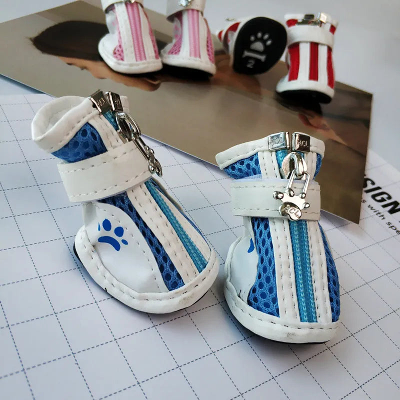 Set of four blue cloth dog shoes with zippers and non-slip soles for small to medium dogs.