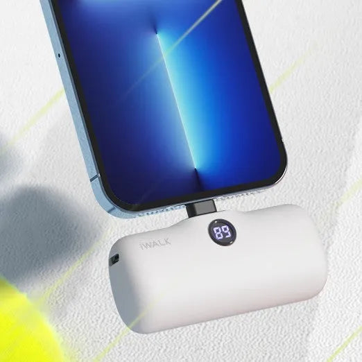 Compact cylindrical lipstick-shaped power bank showing digital battery percentage screen, in choice of colours.