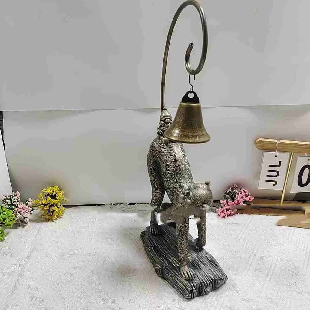Bronze resin cat solar garden lamp on a garden path, outdoor decoration