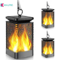 Set of four black solar-powered garden torch lights with flickering flame LED effect on a patio.