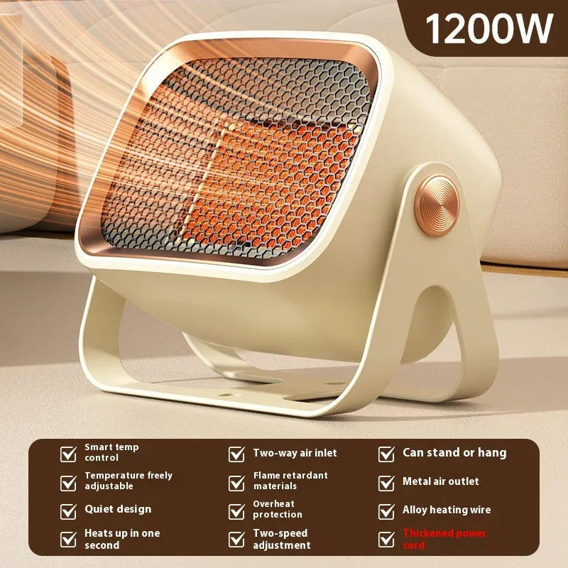 A compact grey desktop ceramic electric heater with a rotatable base on a wooden desk.