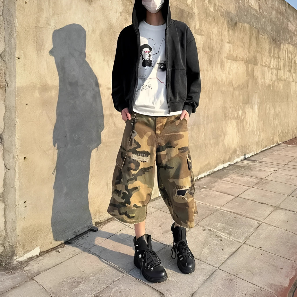 Men's loose-fit camouflage cropped jeans with ripped and patch details on a straight-leg.