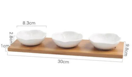 Porcelain ceramic dried fruit dish with compartments on wooden serving board
