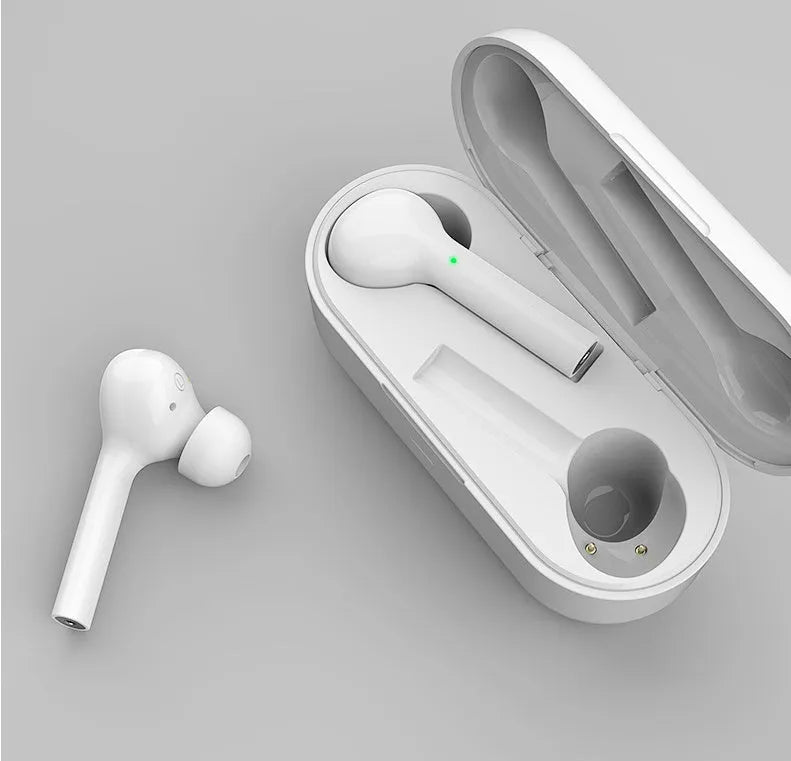 Black and white wireless touch control earbuds with a charging case on a table.