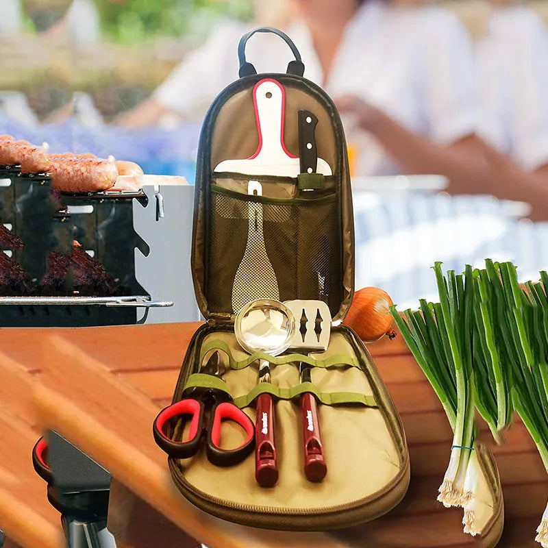 8-piece stainless steel camp kitchen utensil set in black storage bag on outdoor table