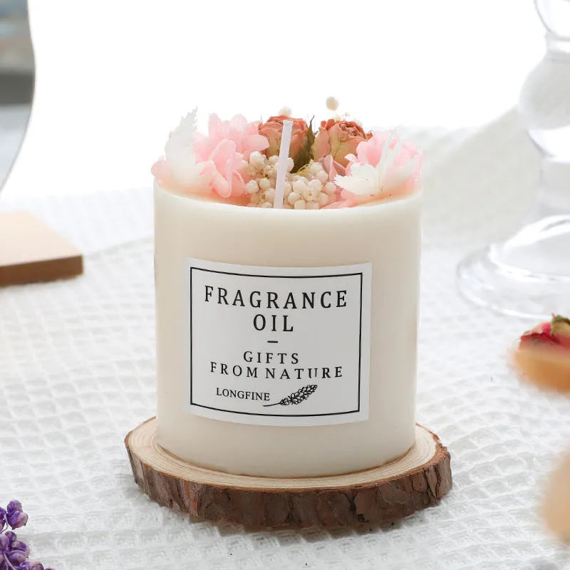 Decorative dried flower candle in jar with wooden chip base, available in nine botanical scents