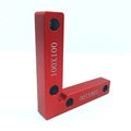 Aluminium woodworking right angle positioning block with engraved scale, shown next to a clamp.
