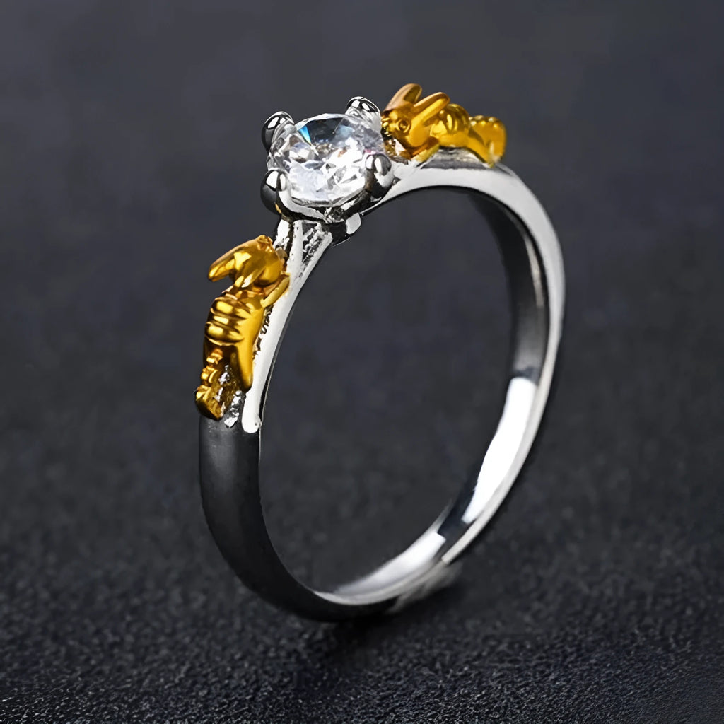 Detailed close-up of a black gold copper crown ring with a central crystal on a finger.