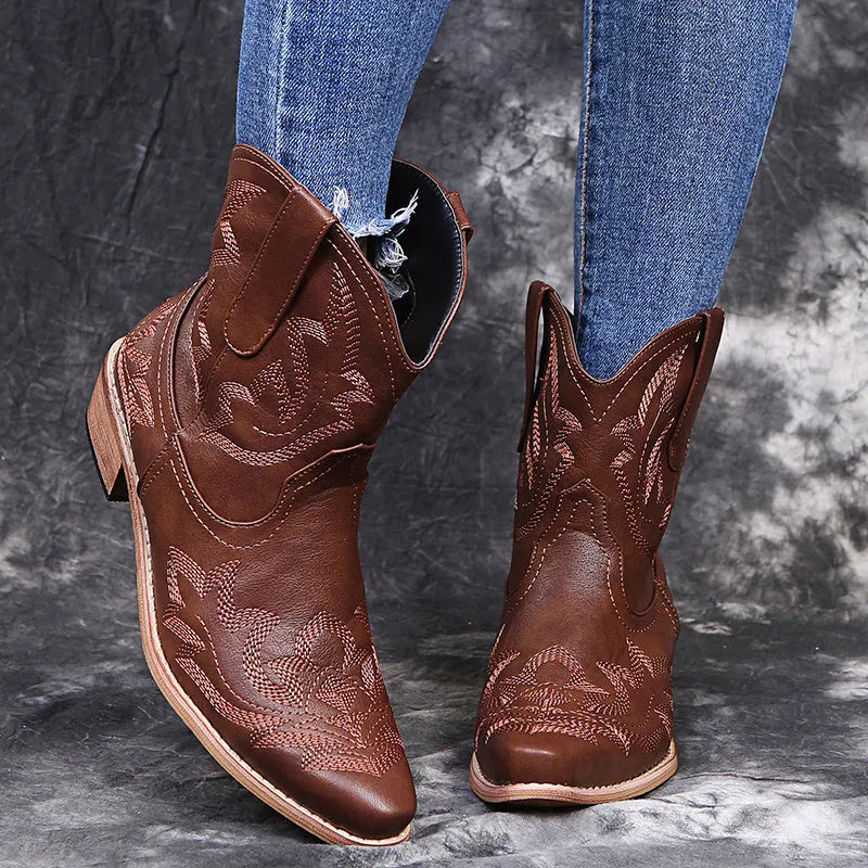 Women's blue embroidered cowboy boots with low wedge heel and pointed toe.