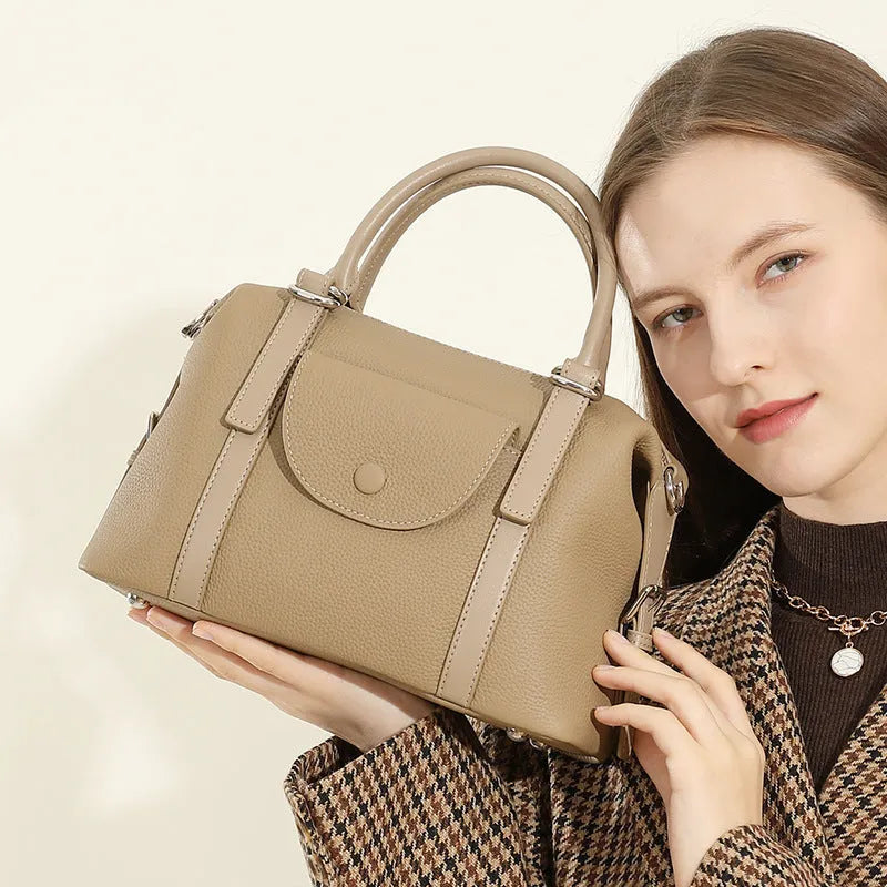 Genuine leather street trend ladies handbag with lock detail in black, brown, or elephant grey