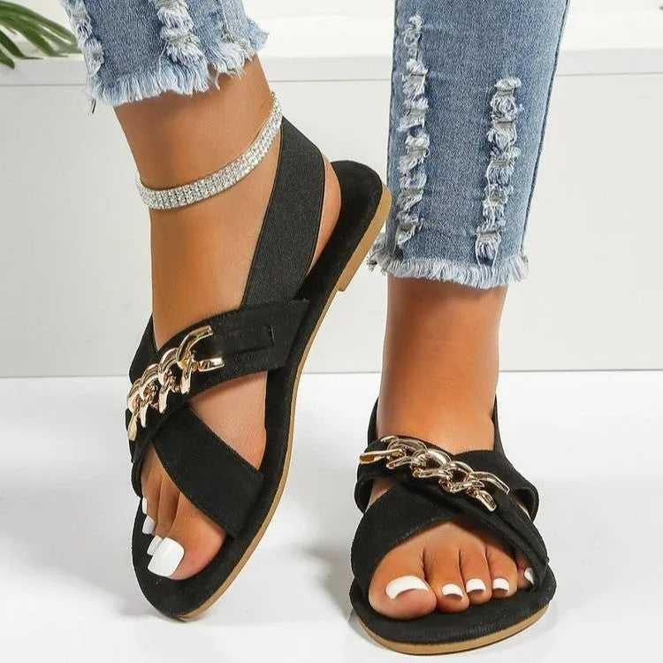 Chains sandals in black with elasticated open toe slide design, rubber sole, and metal detail on PU upper