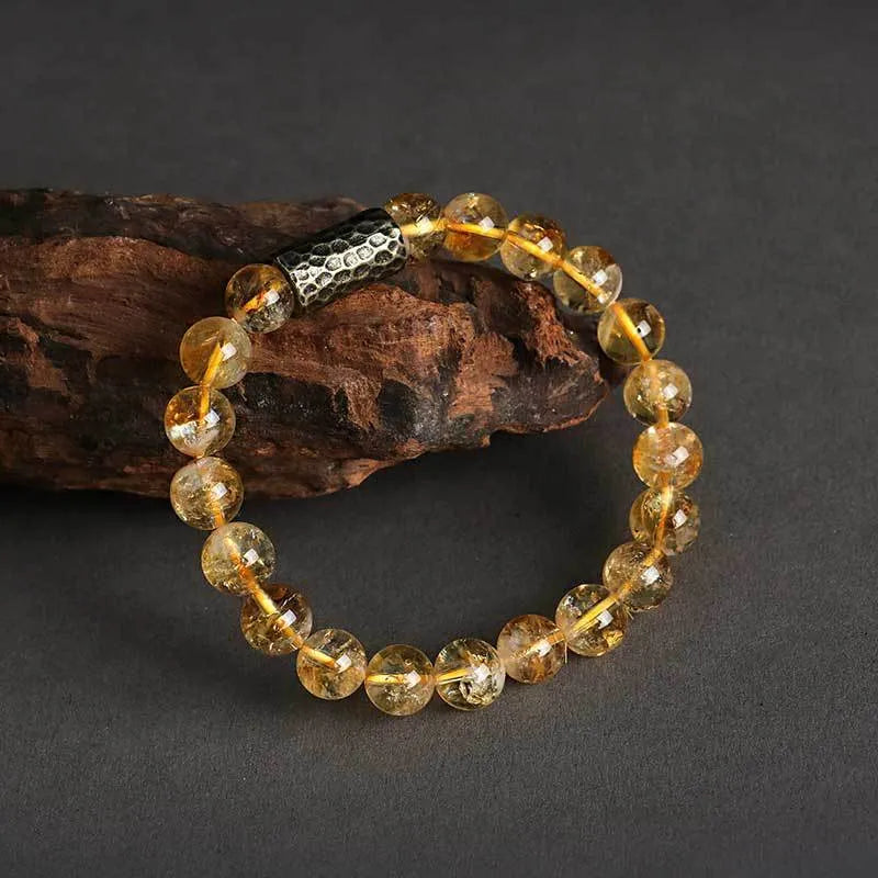 Handmade yellow tower crystal bracelet with double ring design on wrist.