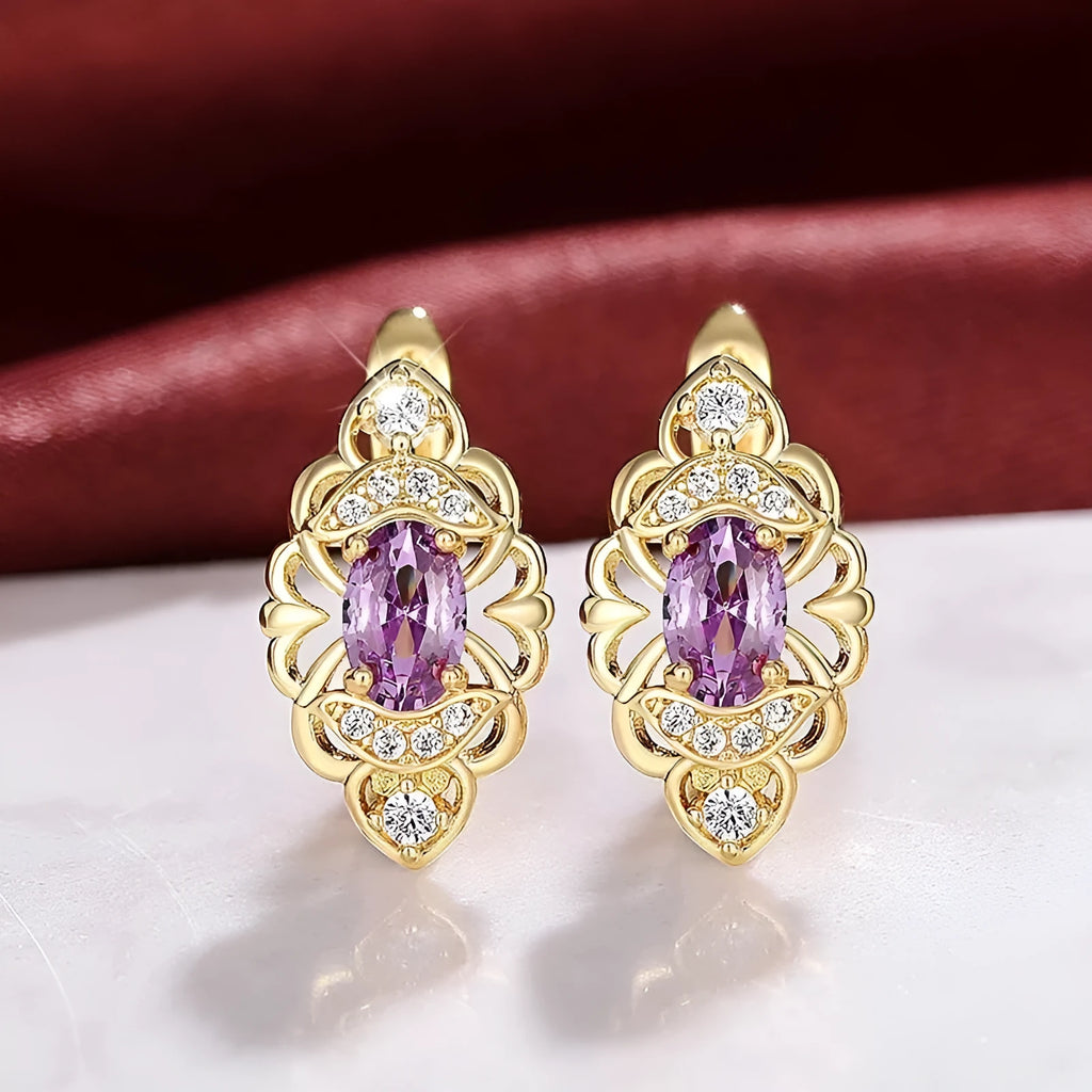 Gold copper flower earrings with hollow design and zircon stones on white background