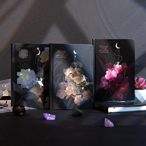 A5 diary book with a luminous purple cover, open to show pages with colour illustrations.