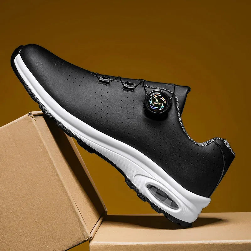 Black and white low-top mesh casual tennis shoes with cross shoulder straps and a flat sole.