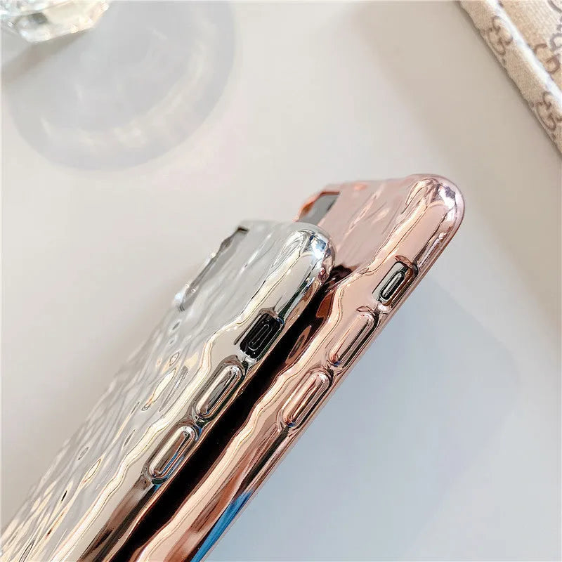 Rose gold folded TPU back cover case for iPhone on a plain background.