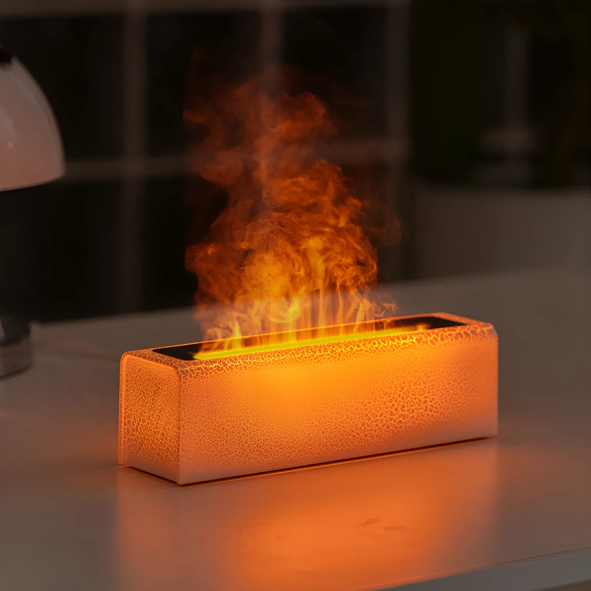 USB lava flame humidifier in black or white with colourful simulated flame and aromatherapy function on a desktop