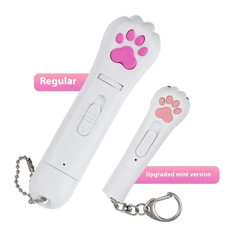 Small white infrared laser cat teasing stick with LED light, shown on a table with a USB charging cable.