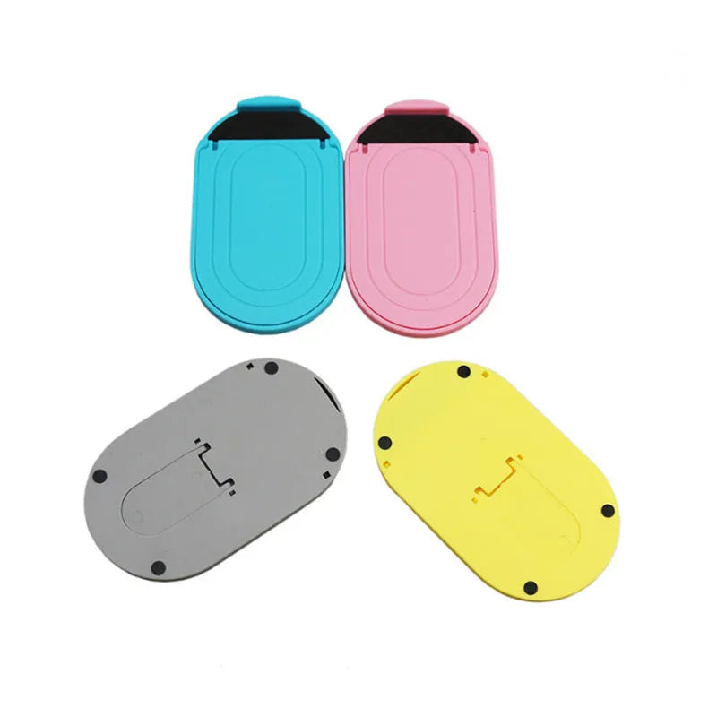 Plastic lazy bracket mobile phone stand in one of six colour options on a desk