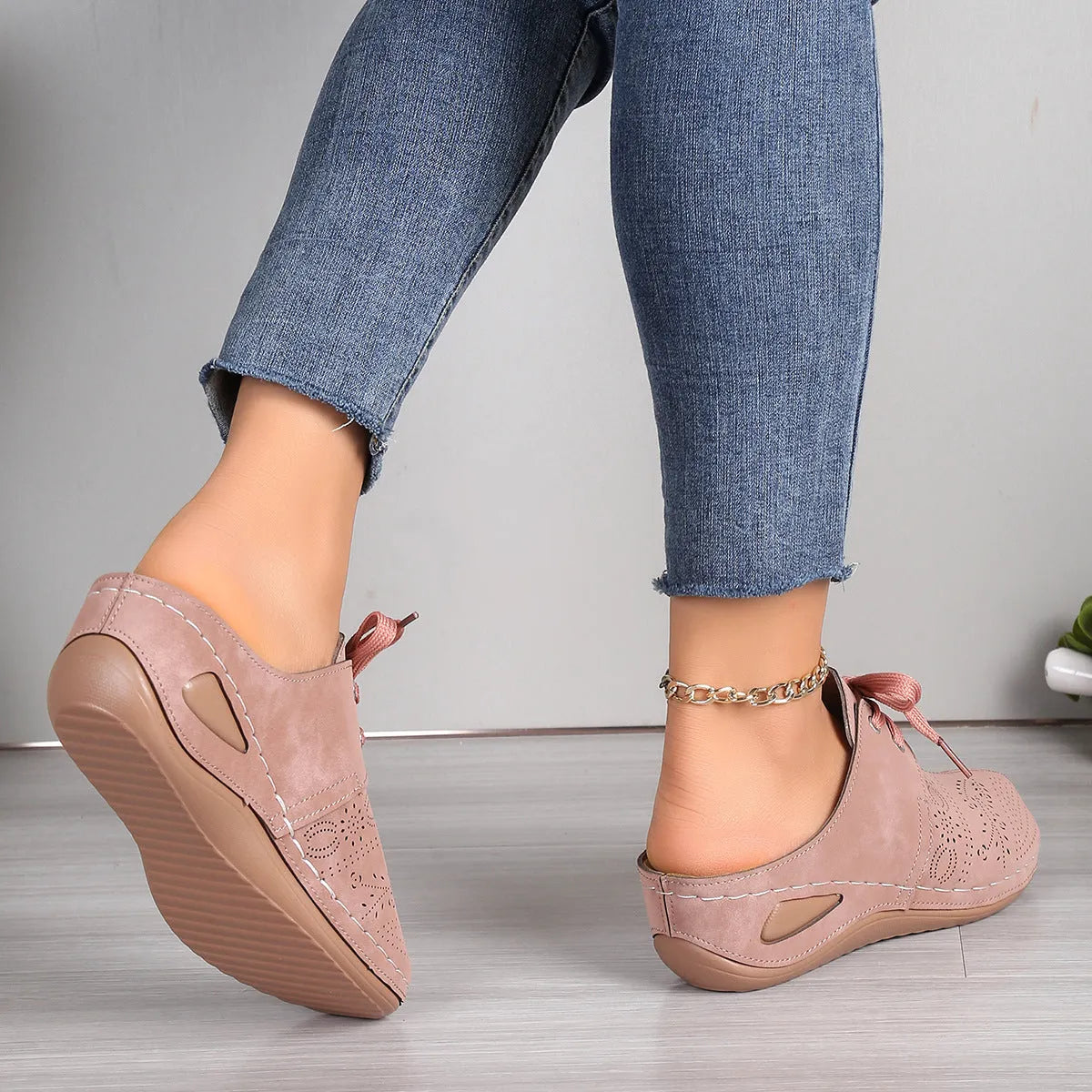 Women's black suede lace-up wedge sandals with a hollow-out design and rubber sole.