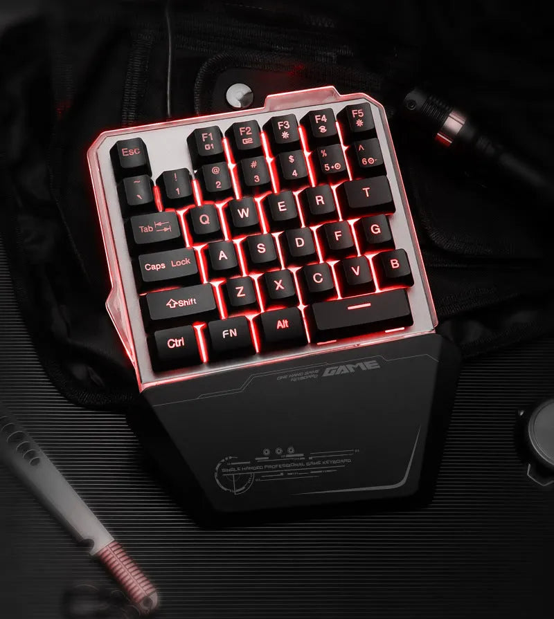 Black G40 Flow one-handed mechanical keyboard with RGB backlit keys on a desk.