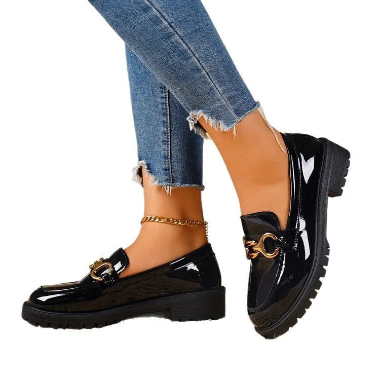 Women's black chunky heel pumps with round toe, thick rubber soles, and metal decorative accents