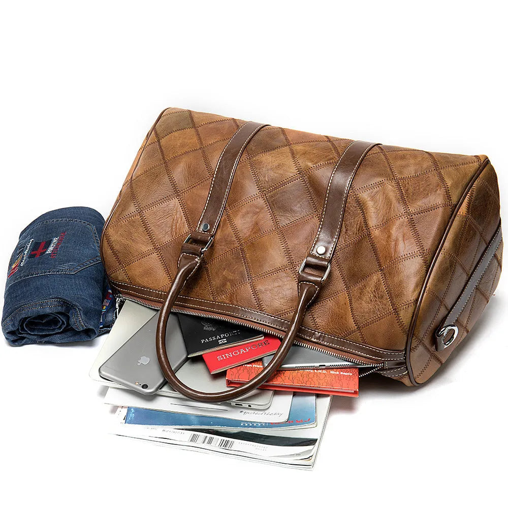 A vintage-style men's leather duffel bag in black with a single strap and internal organiser compartments.
