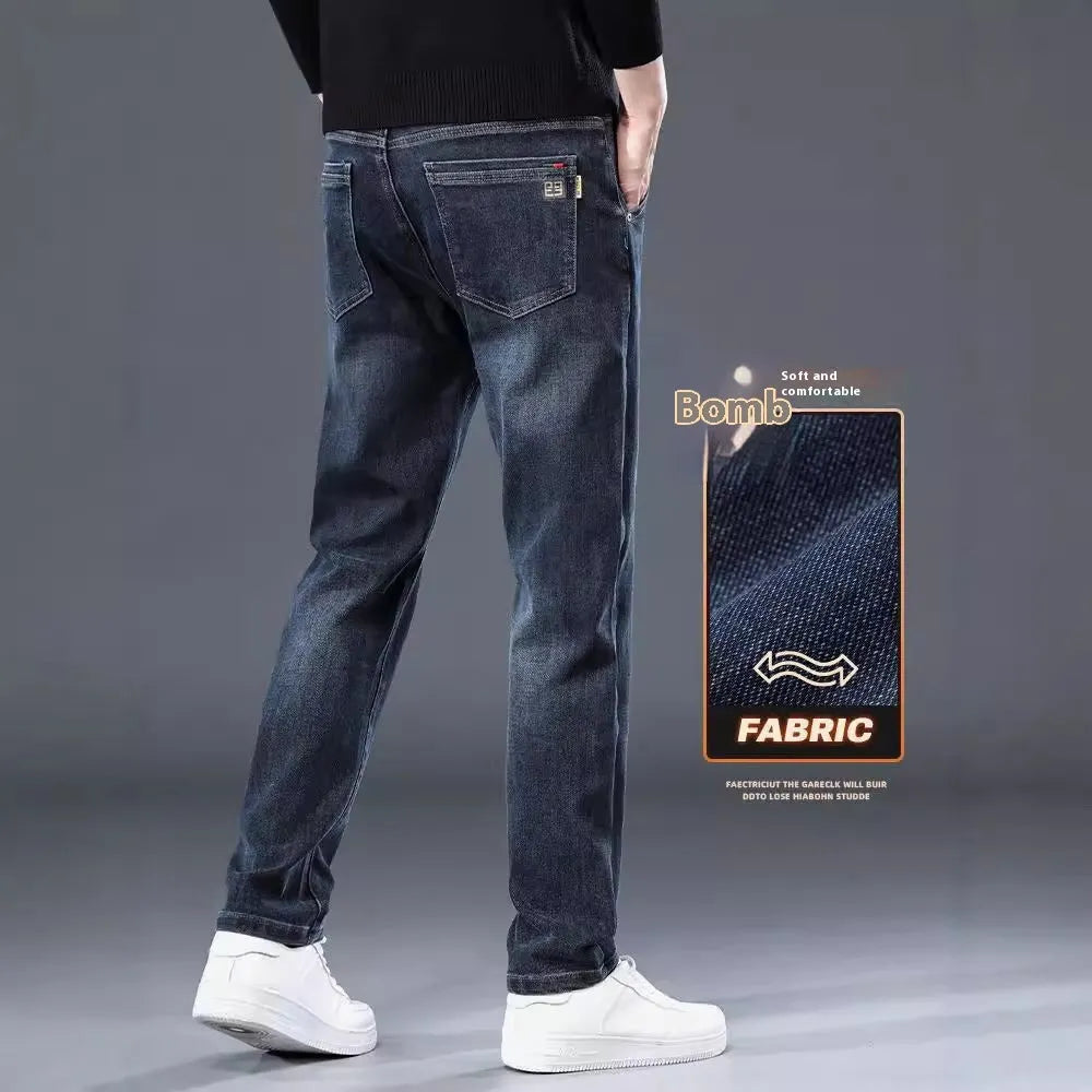 Man wearing slim straight blue grey casual trousers with a zipper fly and mid waist.
