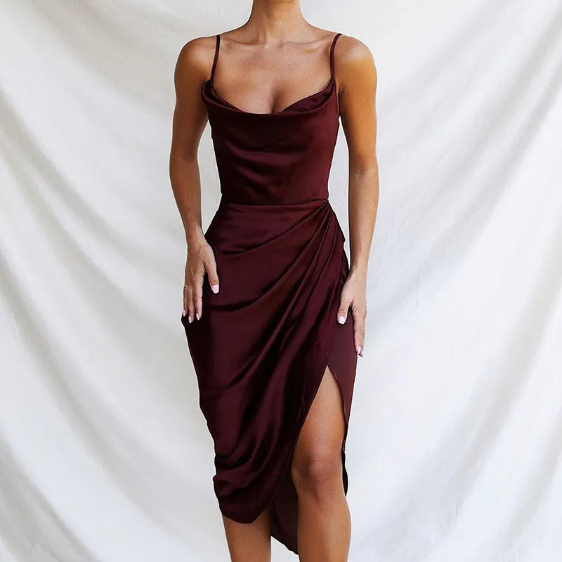 A women's solid-colour satin midi skirt with a high waist, side slit, and sleeveless design.