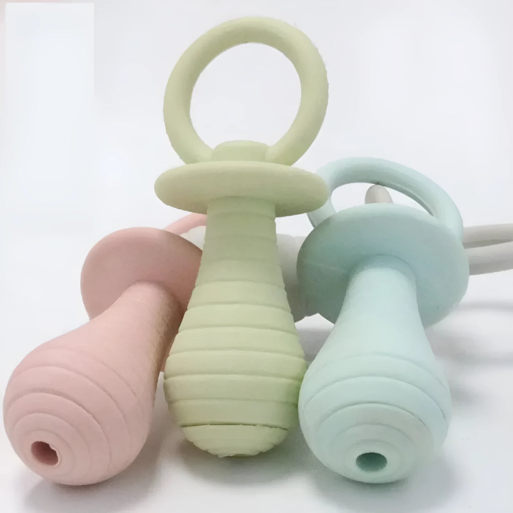 Set of four TPR rubber pet pacifier chew toys with squeakers in blue, gray, green and pink colours