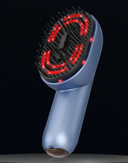 A handheld atomised massage comb with comb teeth, a mist nozzle, and a USB-C charging port on a white background.