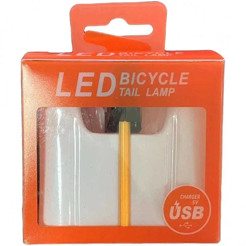 USB-charging waterproof bicycle taillight for night riding shown in blue, pink, red, white and yellow colour options.