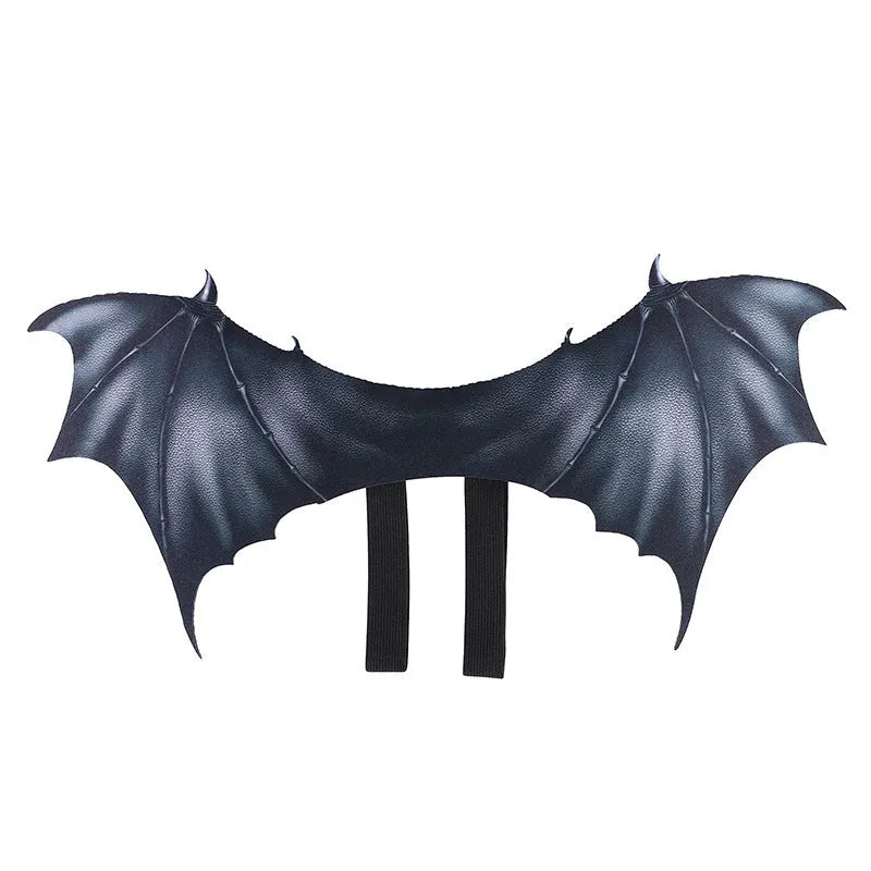 Black cloth bat wings costume accessory for a dog or cat on a Halloween background.