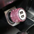 Dual USB car charger with diamond-pattern finish plugged into a car cigarette lighter socket