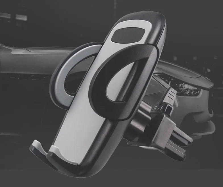 Black plastic universal mobile phone holder attached to a car air conditioning vent.