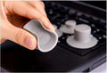 Four grey plastic laptop cooling pads with silicone feet, two large and two small, on a wooden desk.