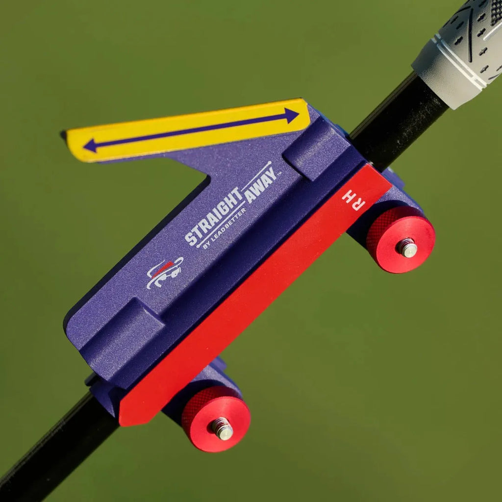 Plastic golf swing plane simulator training aid on a green background.