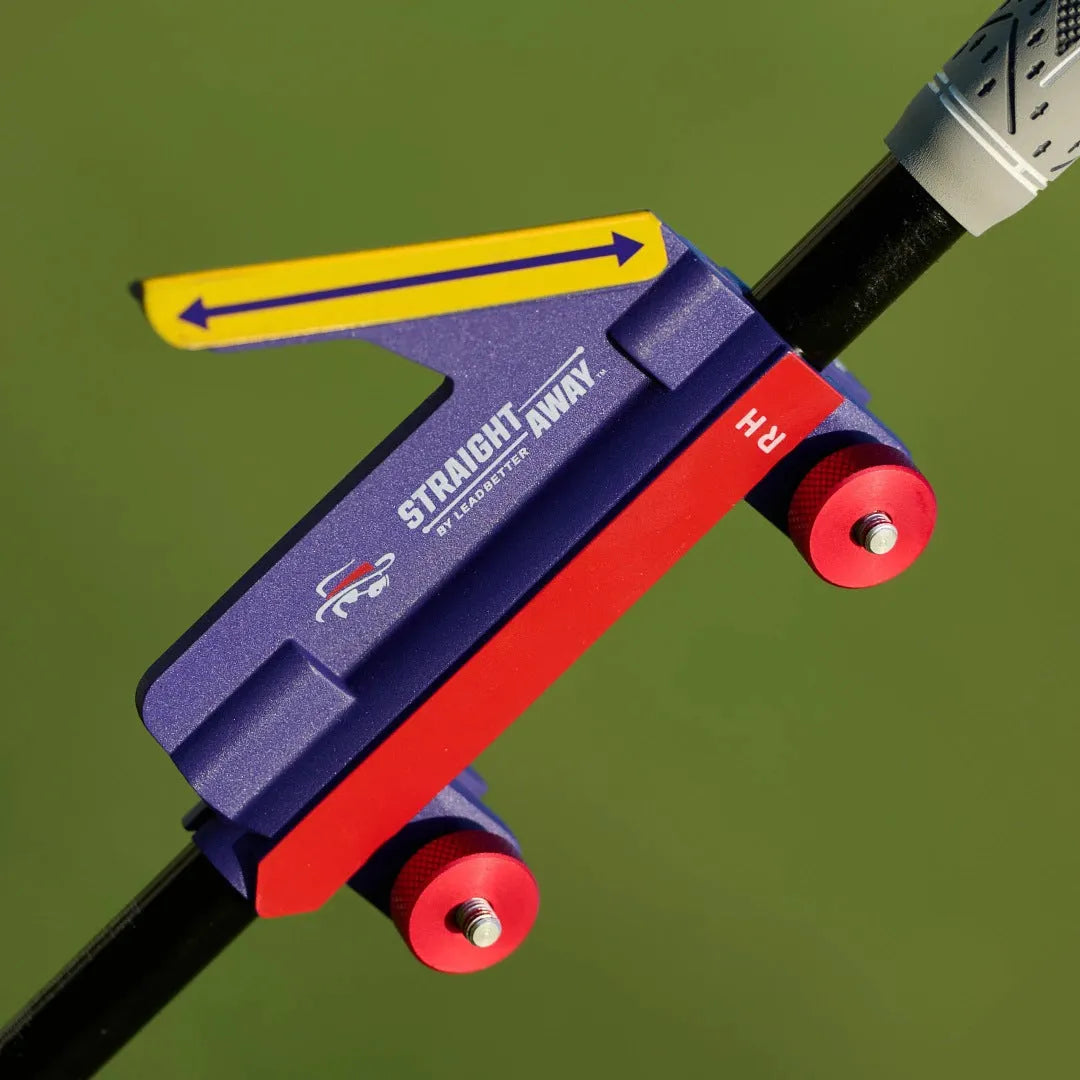 Plastic golf swing plane simulator training aid on a green background.