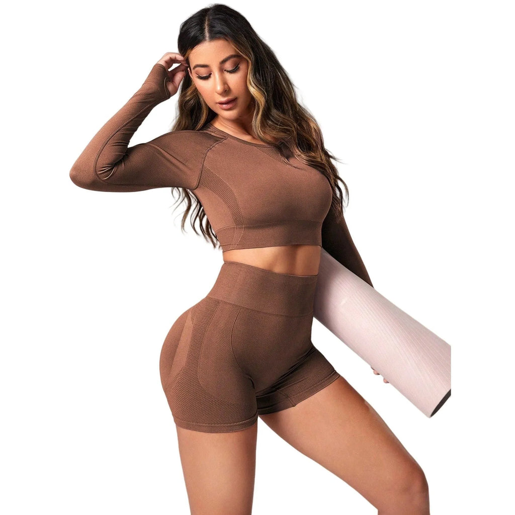 Women's black high-waist yoga pants and long-sleeve top set laid flat.