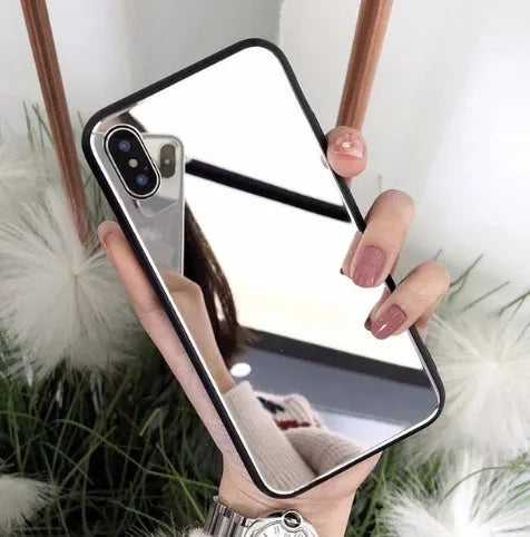 Black mirror phone case for Apple iPhone models X, 7 Plus, and 8 Plus on a table.