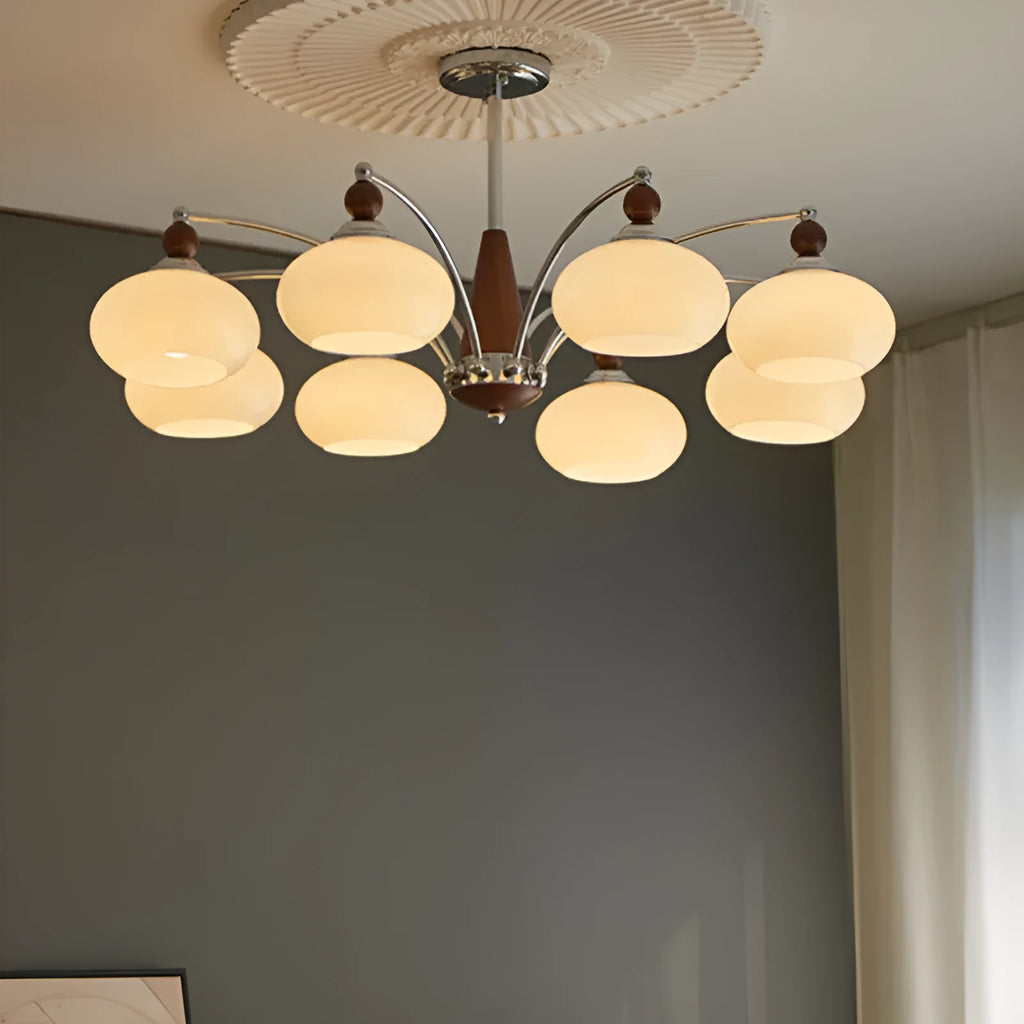 Traditional persimmon glass chandelier with multiple chrome arms and white glass lampshades hanging from a ceiling.